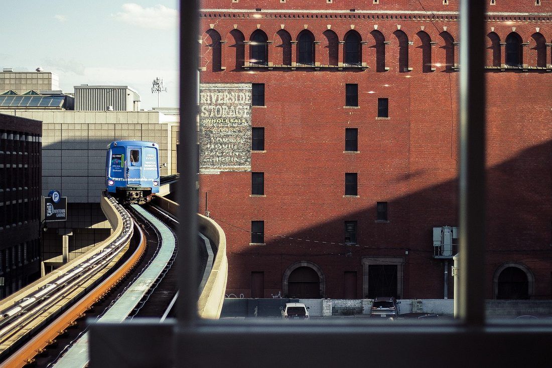 The Detroit People Mover passing a historic brick building